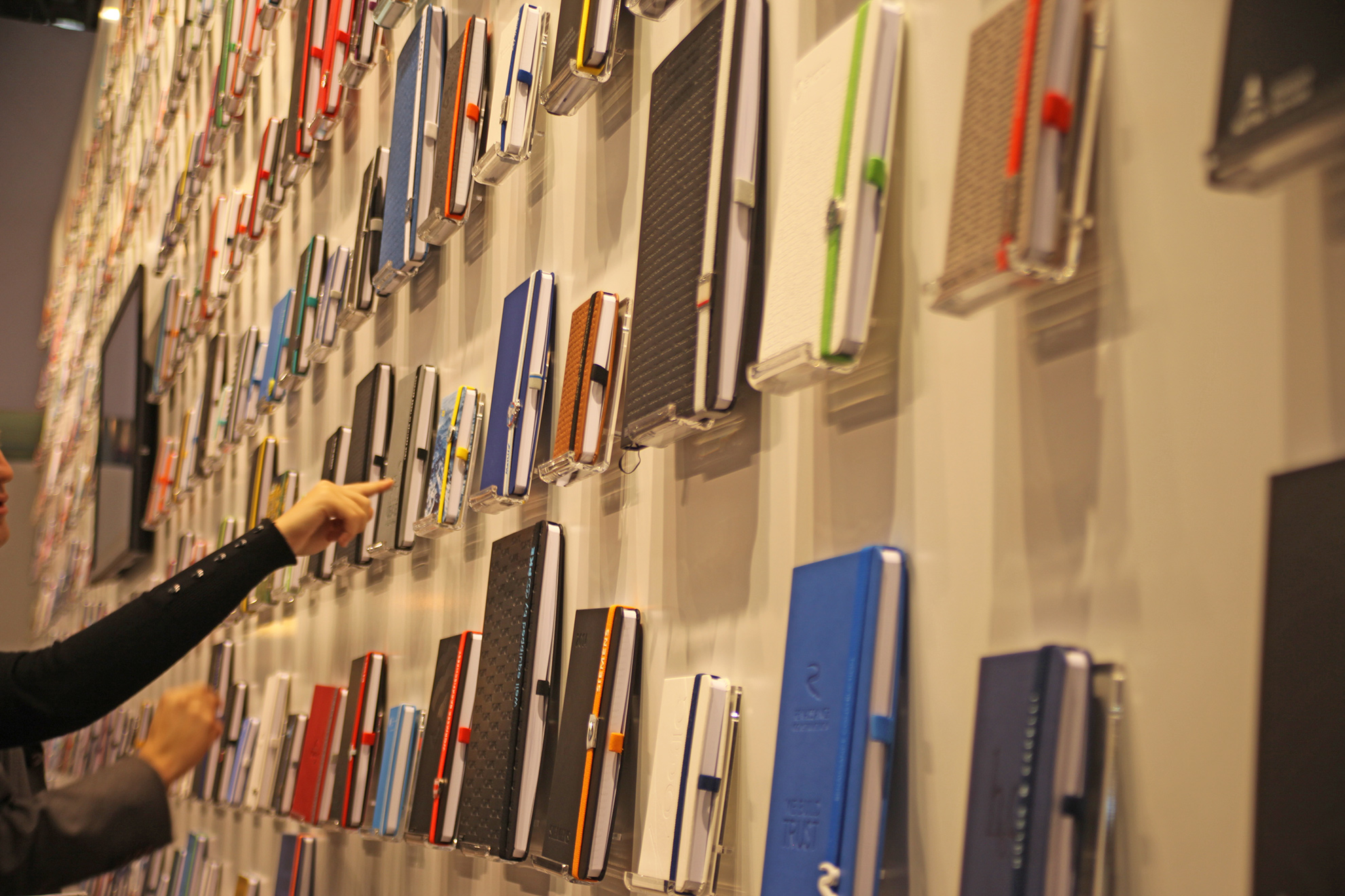 Kunden vor einer Riesenauswahl Notizbücher